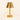 Small brass cordless table lamp with a metal cone shade, lamp on