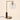 Brass L-neck table lamp with a dark wood collar and clear glass globe, lamp off