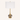 Smoky glass table lamp with a tall white drum shade, flared gold neck, and smoky mercury-glass orb, lamp off