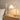 Brass ring table lamp on a light oak nightstand with one book, lamp on