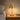 Brass cordless table lamp on a quiet nightstand, shade on