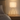 Marble tripod table lamp on a quiet nightstand, shade on