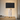 Faux-marble table lamp on a quiet nightstand, shade on