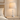 Washed-white spindle table lamp on a pale oak nightstand, lamp on