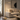 Brass pharmacy floor lamp beside a reading chair, lit