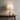 Marble Cone table lamp on a wood console with a ceramic bowl, lamp on