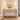 White wood lantern table lamp pair centered on foyer console — entryway lifestyle, blank books, both on.