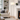 Brushed nickel swing-arm floor lamp in a quiet living room corner, lit