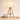 Wood tripod table lamp next to a book for scale, shade on