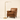 Brass pharmacy floor lamp next to a chair for scale, lit