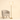 Gold tier floor lamp next to a chair for scale, lit