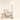 Nickel glass column floor lamp next to a chair for scale, lit