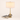 Smoky glass table lamp next to a book and mug for scale, shade on