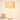 Hourglass table lamp next to a book for scale, shade on