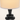 Close-up of the tall white drum shade and top stacked black discs, lamp on