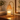 Amber Glass Tree Candle Warmer Lamp glowing on a walnut console in the evening
