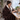 Woman working at a desk with the coffee heated throw blanket over her shoulders and lap