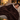Woman napping on a sofa under the coffee heated throw blanket