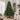 Full green artificial Christmas tree in a bright living room