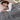 Woman asleep in bed under the gray weighted throw blanket