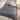 Gray weighted throw blanket spread over a single daybed