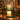 Green Glass Tree Candle Warmer Lamp on a mantel with a pine garland