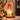 Pink Glass Tree Candle Warmer Lamp on a white console with fir sprigs and ornaments