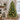Pre-lit green artificial Christmas tree in a bright living room