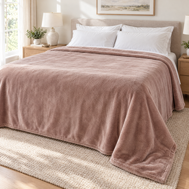 Taupe king heated blanket spread across a made bed