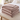 Taupe flannel heated blanket folded on a bench at the end of a bed