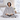 Woman reading on a bed wearing the grey wearable heated blanket with the hood up