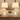 Closeup of distressed white wood lantern farmhouse pair — square to console, both lamps on, clean stems.