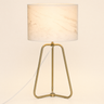 Bronze tripod table lamp with a marble-pattern drum shade, lamp on
