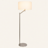 Brushed nickel swing-arm floor lamp with white linen drum shade, lit, cream studio