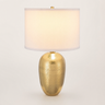 Gold mesh table lamp with a tall white drum shade and textured gold egg base, lamp on