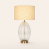 Ribbed glass table lamp with a beige linen drum on a clear ribbed egg base, lamp on