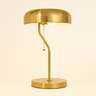 Gold metal dome table lamp with a pull chain, lamp on