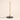 Slim vertical LED table lamp with gold housing and black disc base, lamp on