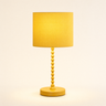 Ochre yellow bobbin table lamp with a matching mustard drum shade, lamp on