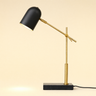 Black marble desk lamp with a brass crane arm and matte-black pill shade, lamp on