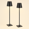 Pair of matte-black cordless table lamps with tapered metal shades and square bases, lamps on