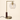 Brass L-neck table lamp with a dark wood collar and clear glass globe, lamp on