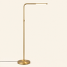 Brass pharmacy floor lamp with adjustable LED arm, lit, cream studio