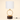 Dark wood cylinder with a vertical gold ring and a white fabric drum shade, lamp off