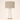 Off-white glass hourglass table lamp with a tan linen drum shade, lamp off