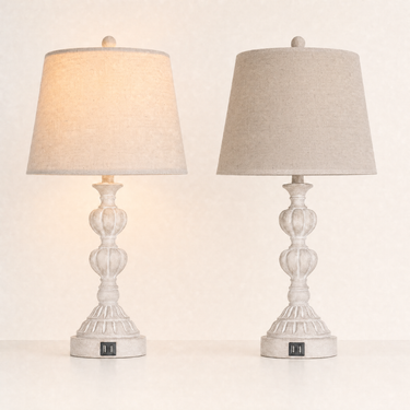 Pair of washed-white spindle table lamps, left lamp on and right lamp fully off