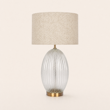Ribbed glass table lamp with a beige linen drum on a clear ribbed egg base, lamp off