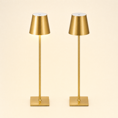 Pair of slim brushed-gold cordless table lamps, left on and right off