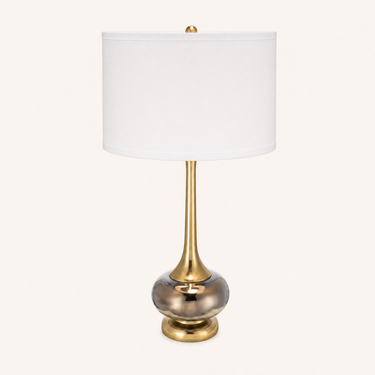 Smoky glass table lamp with a tall white drum shade, flared gold neck, and smoky mercury-glass orb, lamp off