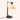 Three-quarter view of the wood crane arm table lamp, shade on